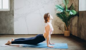 Woman in Purple Long Sleeve Shirt and Black Denim Leggings in Yoga Pose